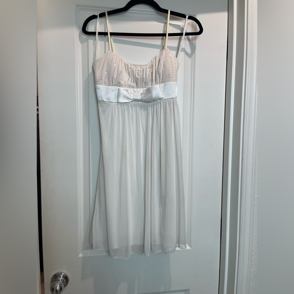 Ruby Rox Ivory Dress with bow and sequin top. Tie back in the back.